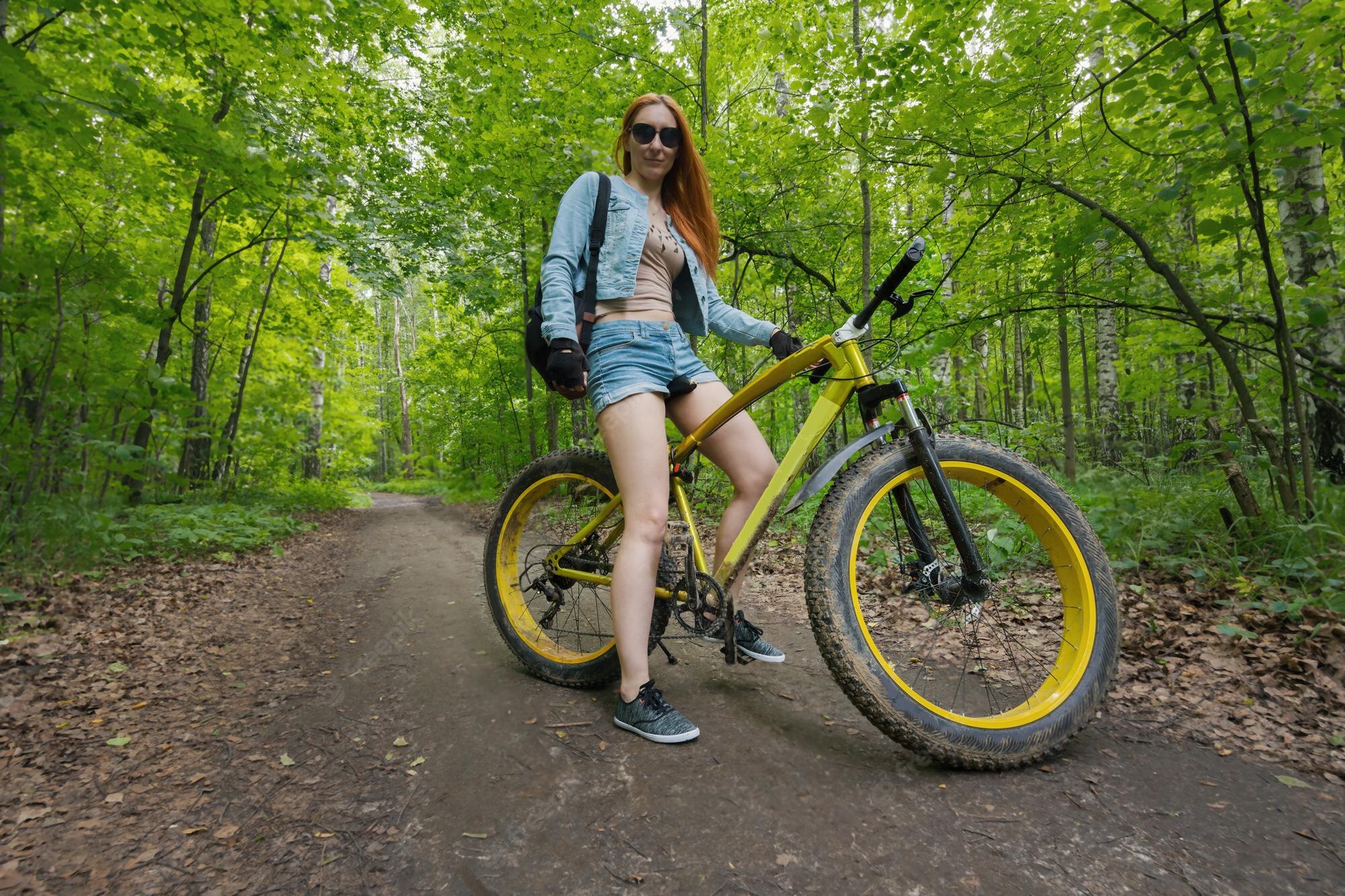 beautiful-girl-shorts-glasses-yellow-bicycle-summer-park_274719-1255